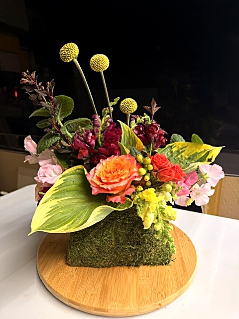 Moss handbag with hosta and peach roses